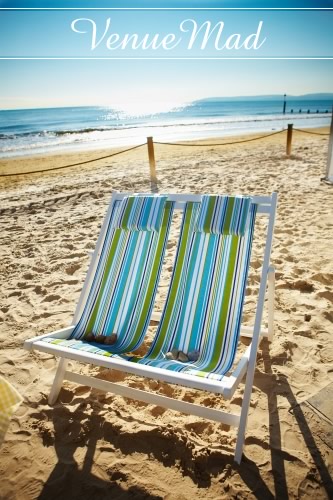 Deckchairs On Sandy Beach